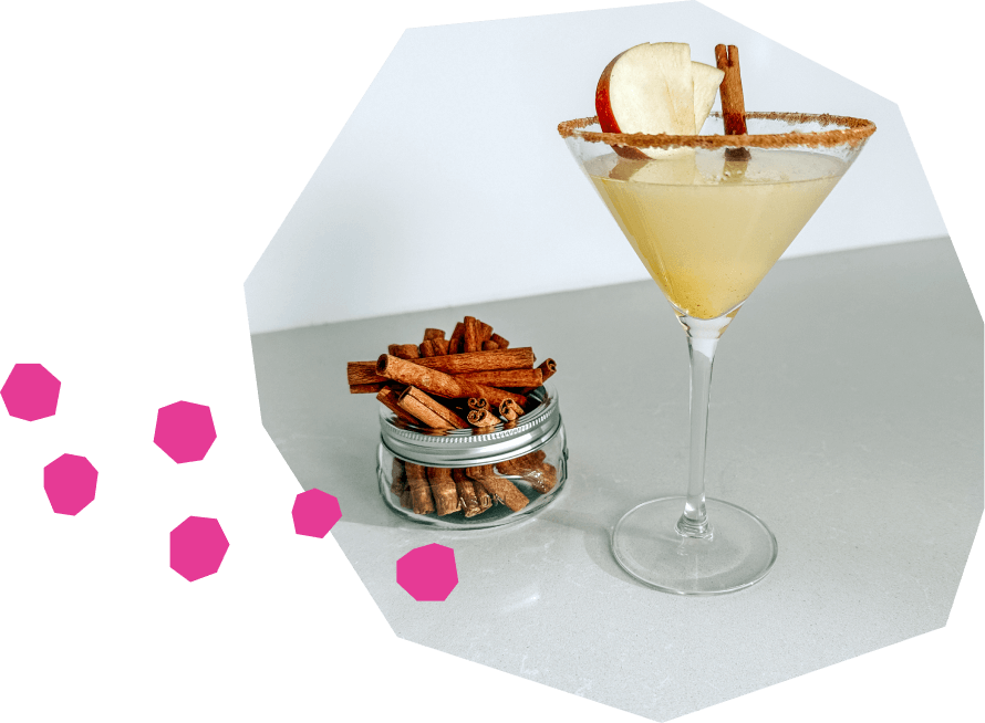 Fruity cocktail with apples and cinnamon, served in a martini glass, made with vodka, sparkling water, and sparkling wine.